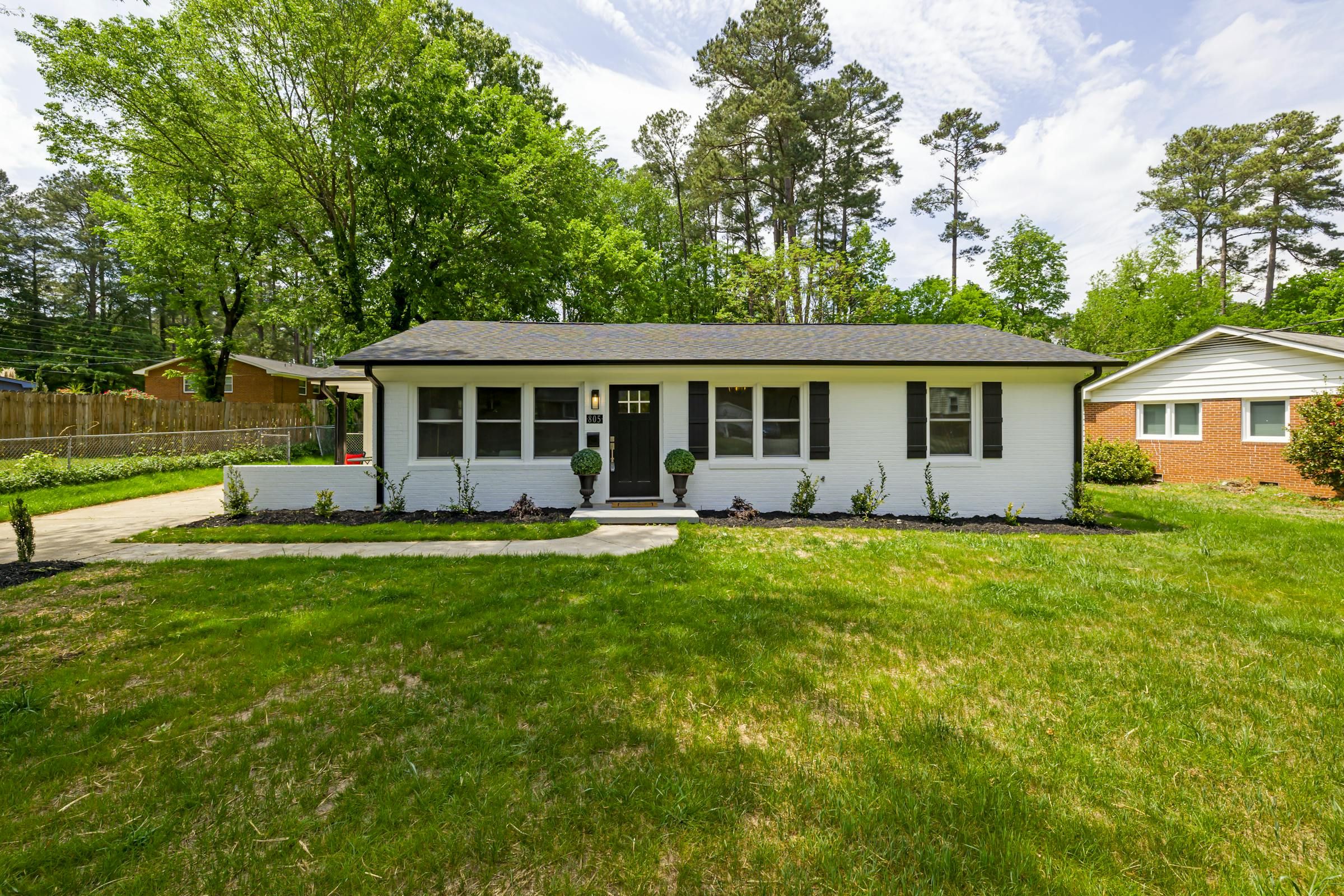 Single-storey post-war bungalow with a mature front yard in a Calgary residential neighbourhood