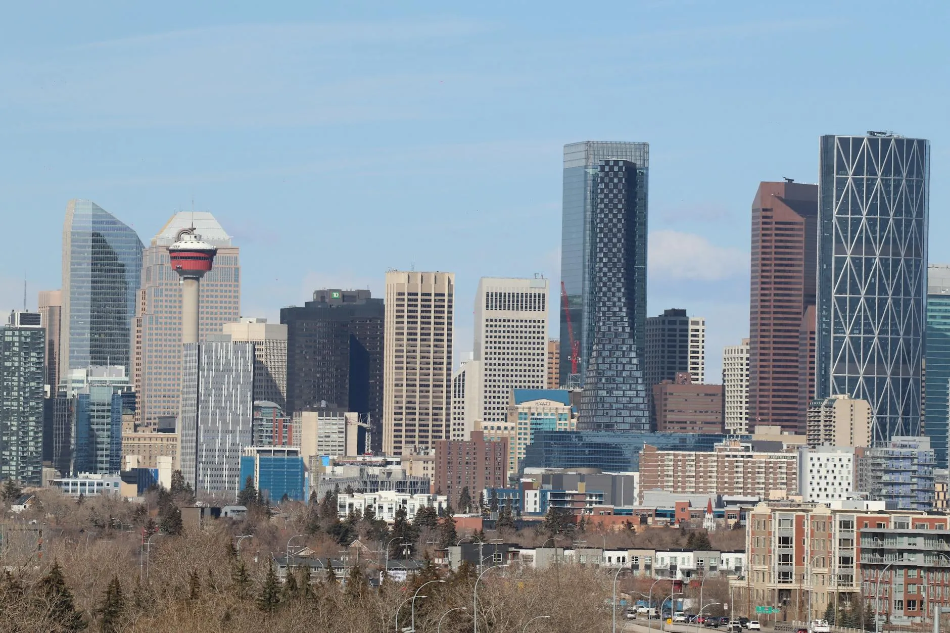 The downtown Calgary skyline and Calgary Tower under a clear sky.