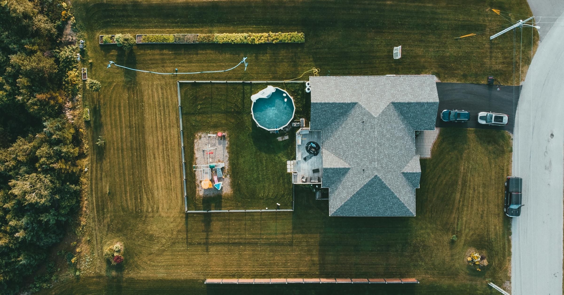 Top-down aerial view of a single detached property showing the home, yard, and surrounding lot