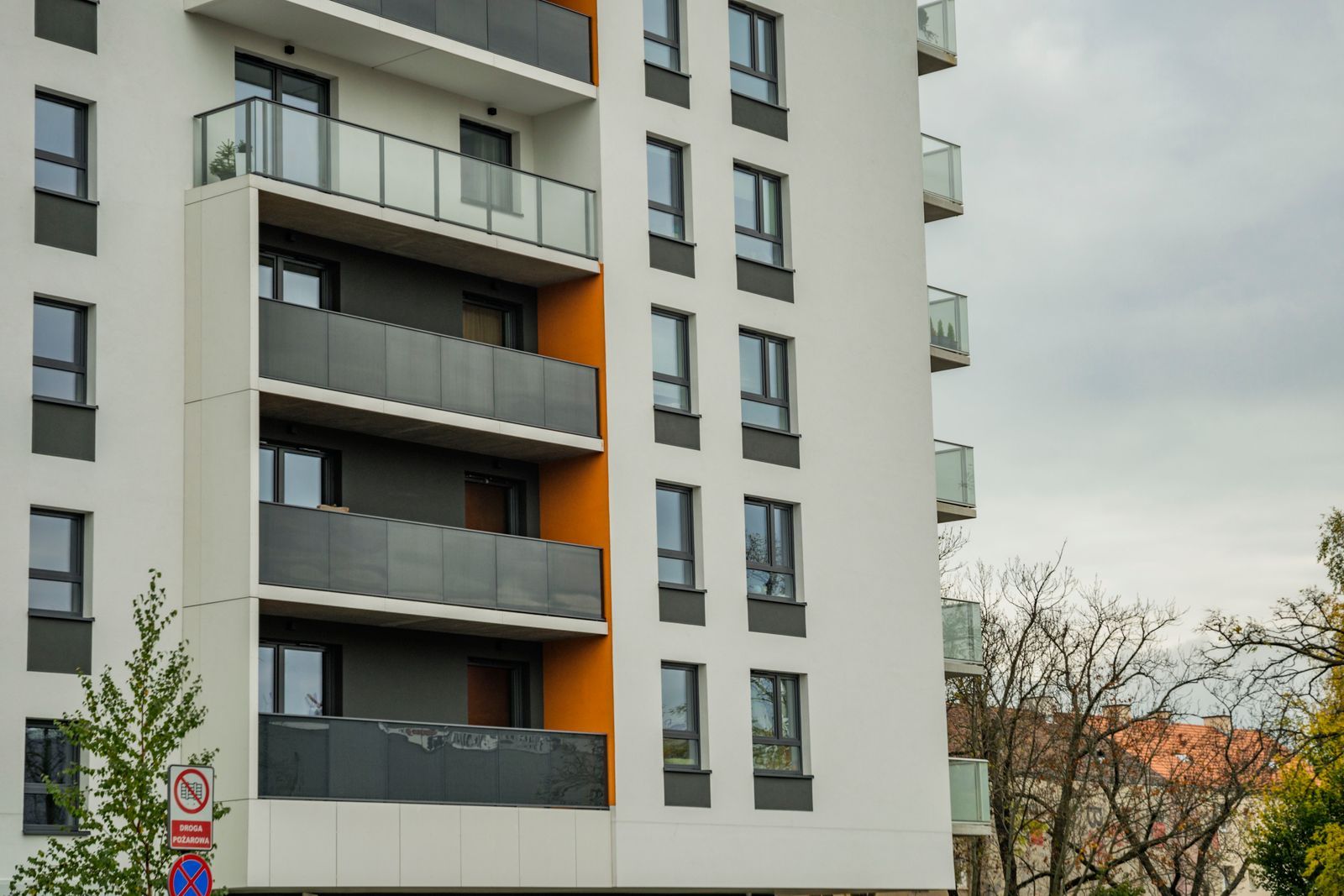 Balconies on a mid-rise Calgary apartment building against an overcast sky